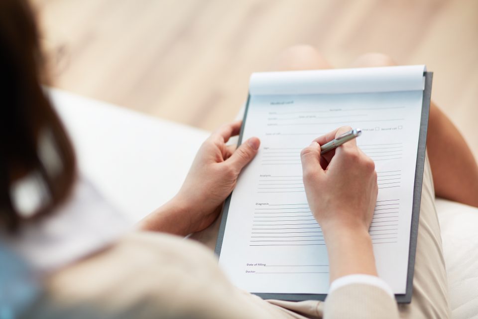 Female counselor writing down some information about her patient