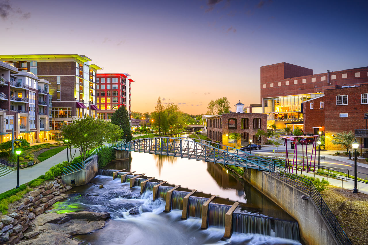 Beautiful picture of downtown Greenville, SC riverwalk at sunset