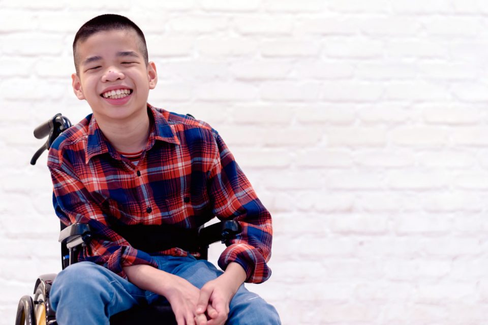 Young boy in wheelchair smiling