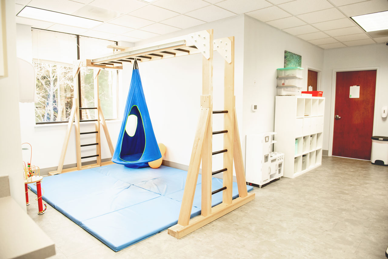 Carolina Therapeutics occupational therapy room with blue and wooden equipment