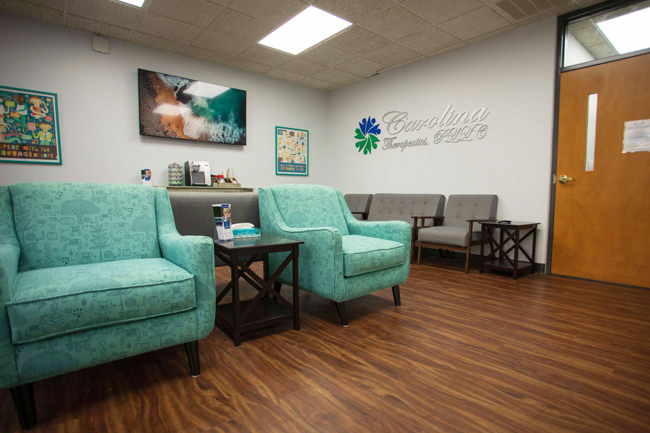 Carolina Therapeutics Greenville, NC waiting room with plush green and grey chairs